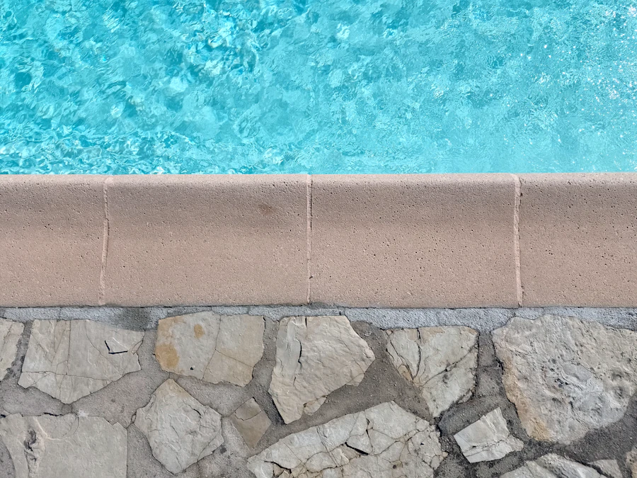 Clear blue swimming pool water meeting stone edge