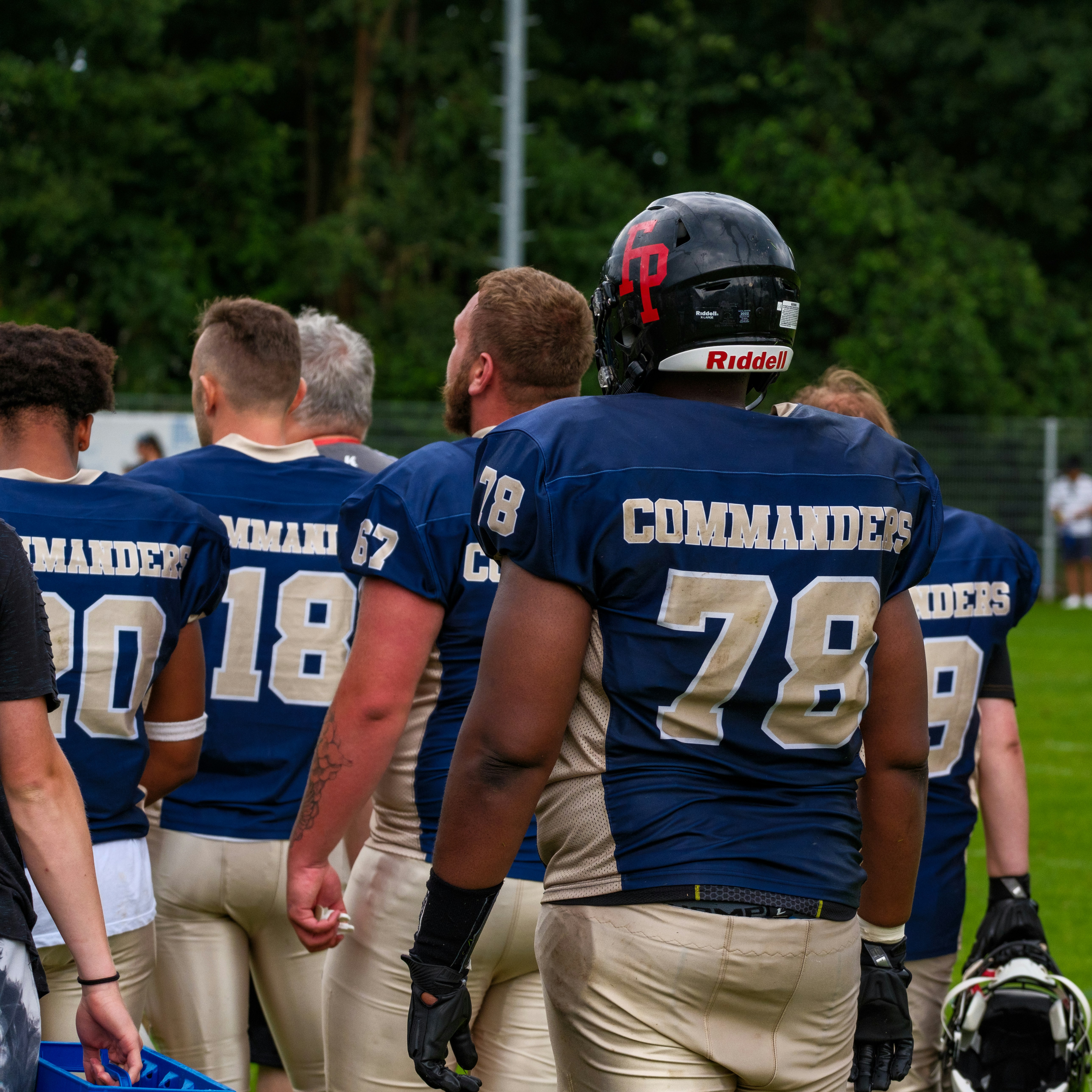 American football players in uniform walking on field