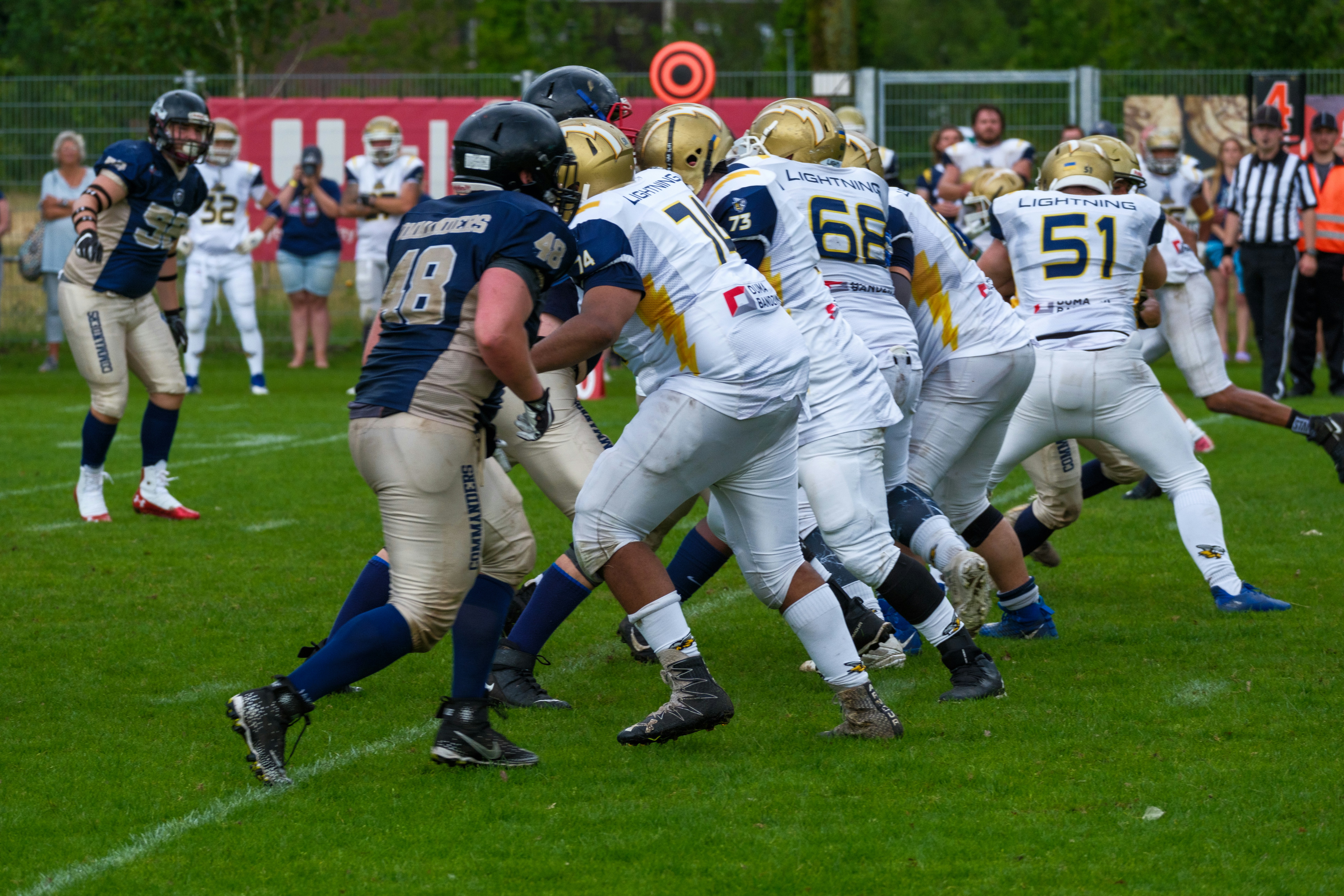 American football players in a huddle on field.