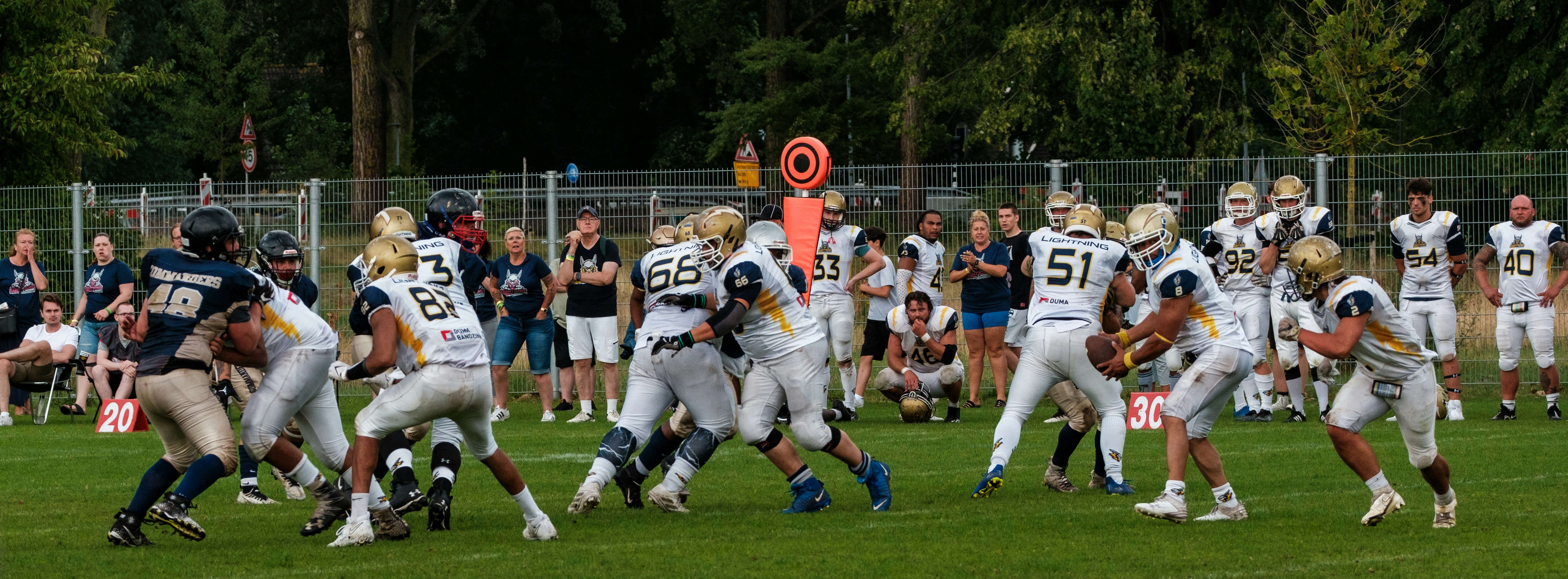 American football players in action on a grassy field.