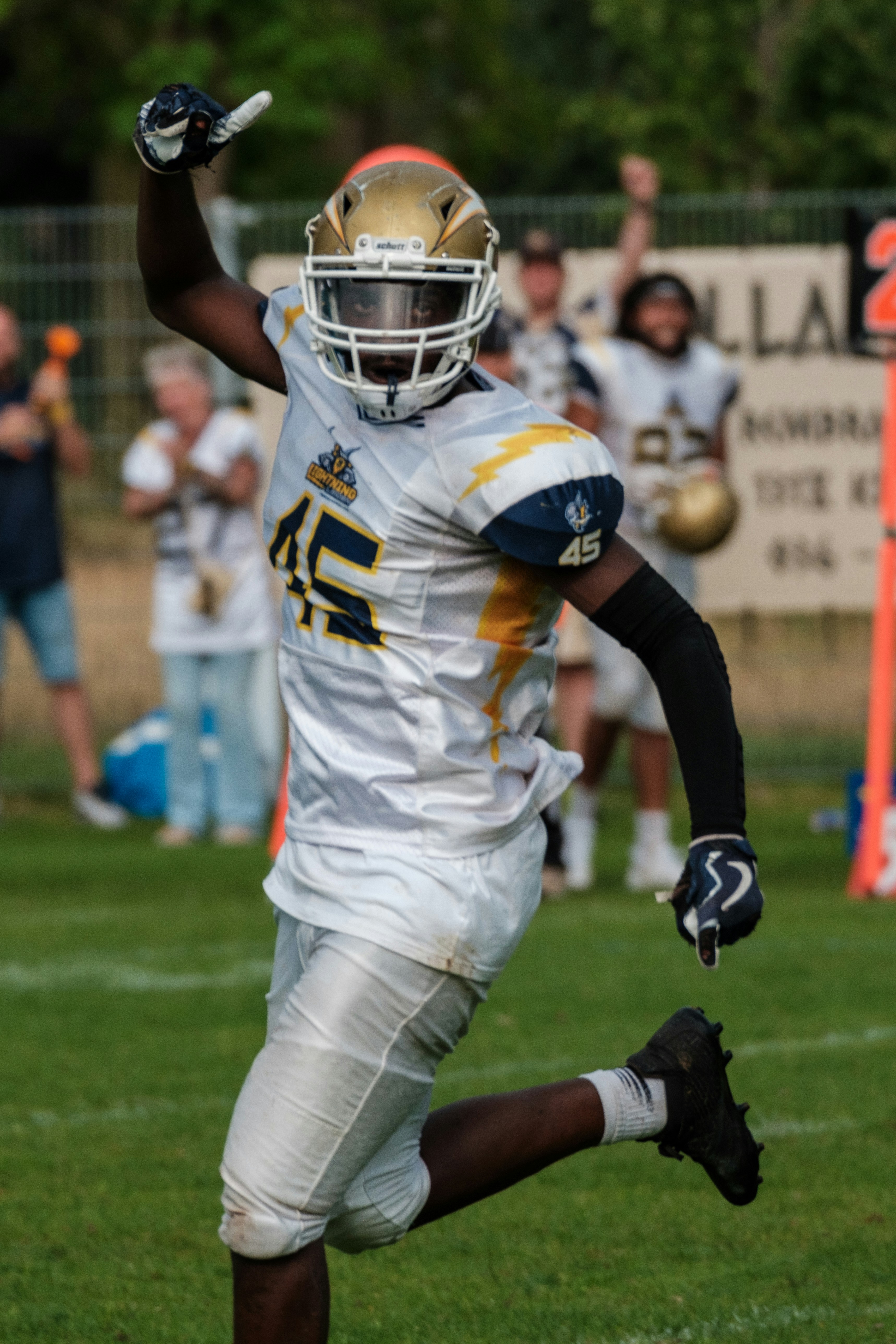 Football player in uniform celebrating on field