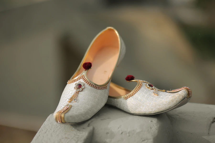 Ornate white and gold traditional Indian juti shoes from Agra, Uttar Pradesh