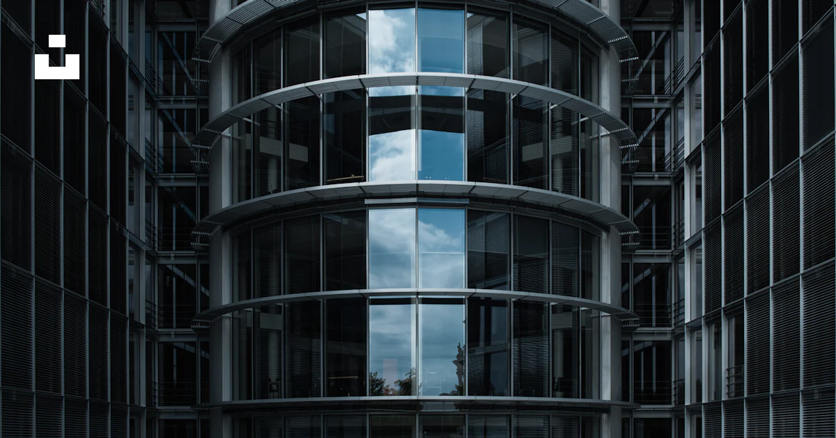 Modern glass building with reflective windows and geometric patterns ...