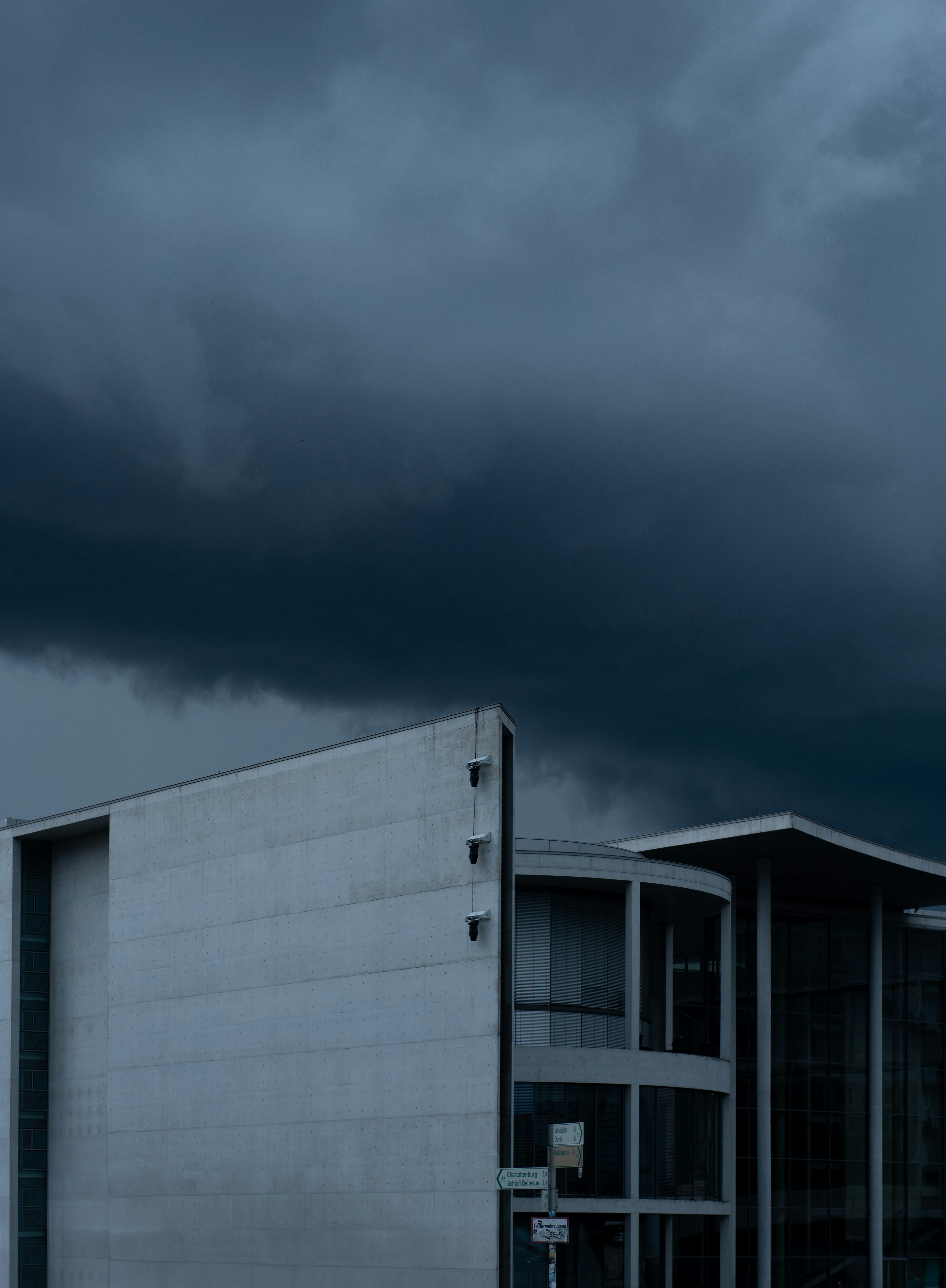 Modern building under a dark, stormy sky