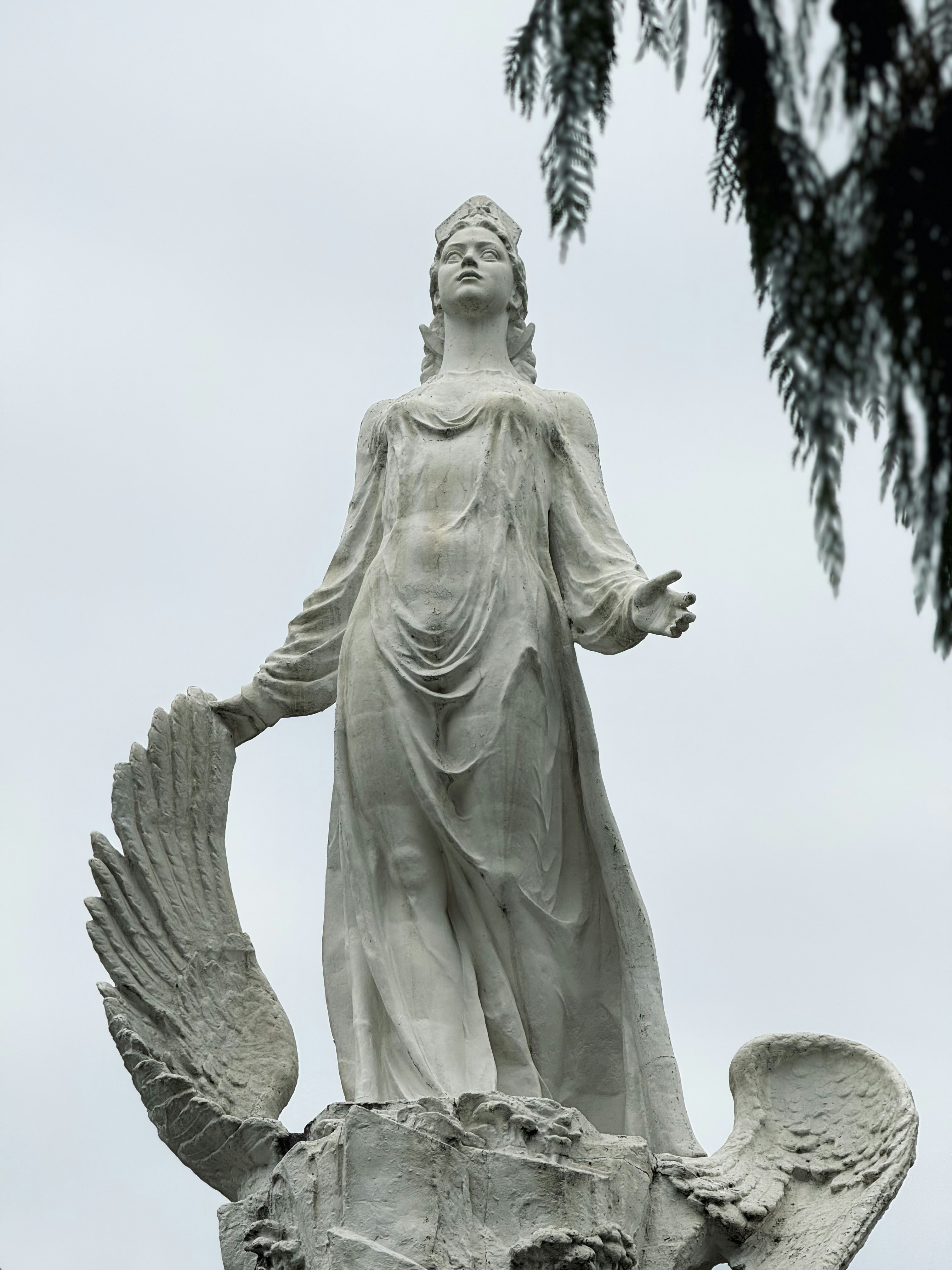Stone statue of a woman with wings