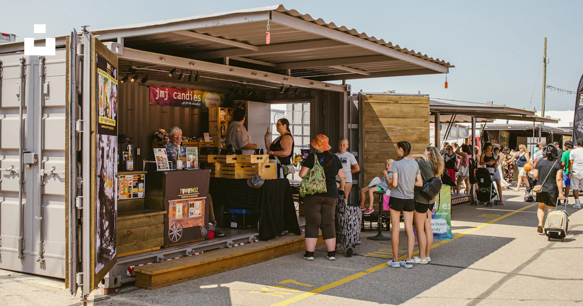 People gathered at an outdoor shipping container cafe. photo – Free ...
