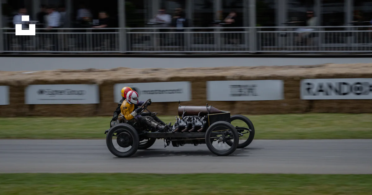 Two Drivers One Wheel Vintage race car with two drivers speeds along track. photo – Free ...