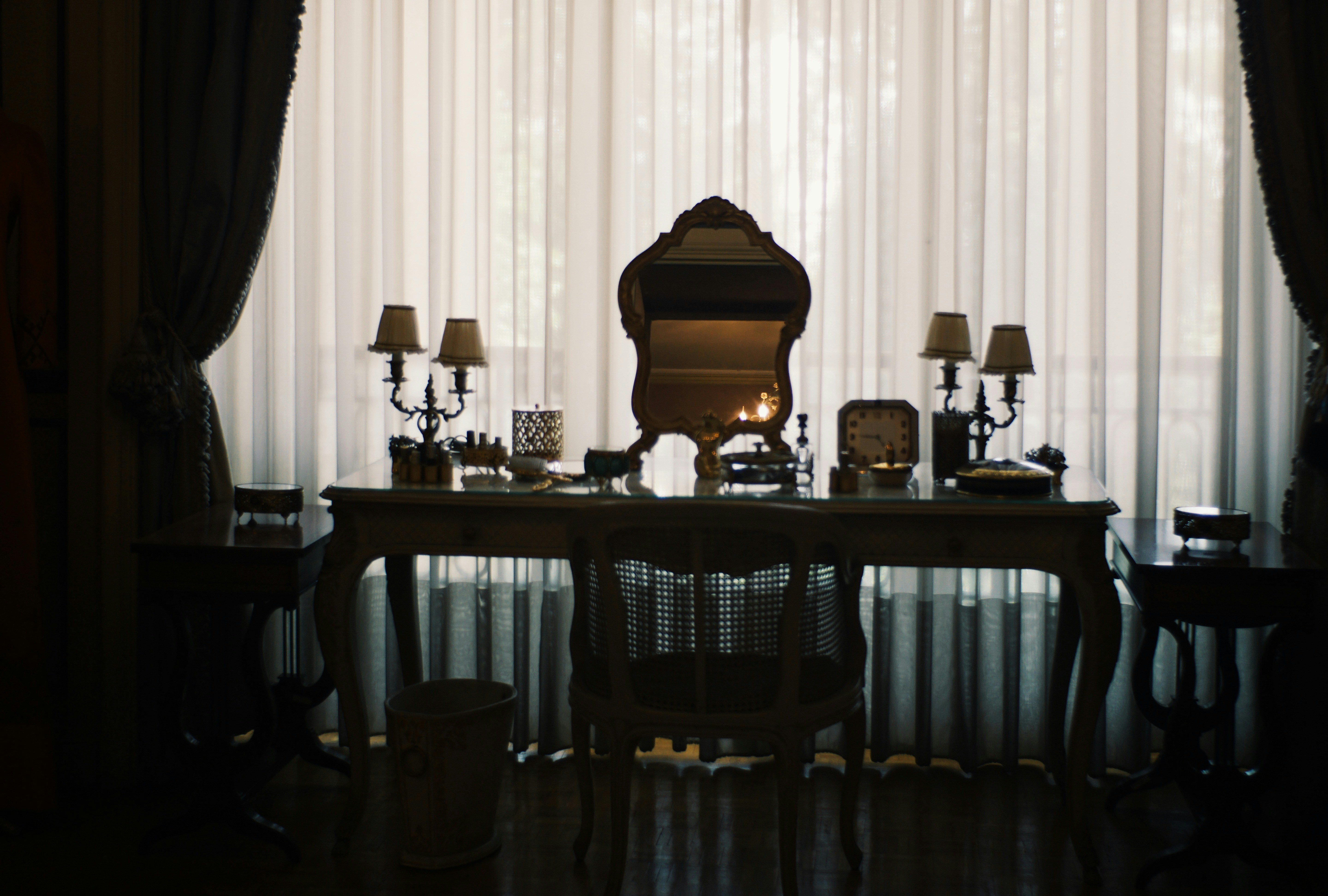 Elegant vanity table with mirror and lamps