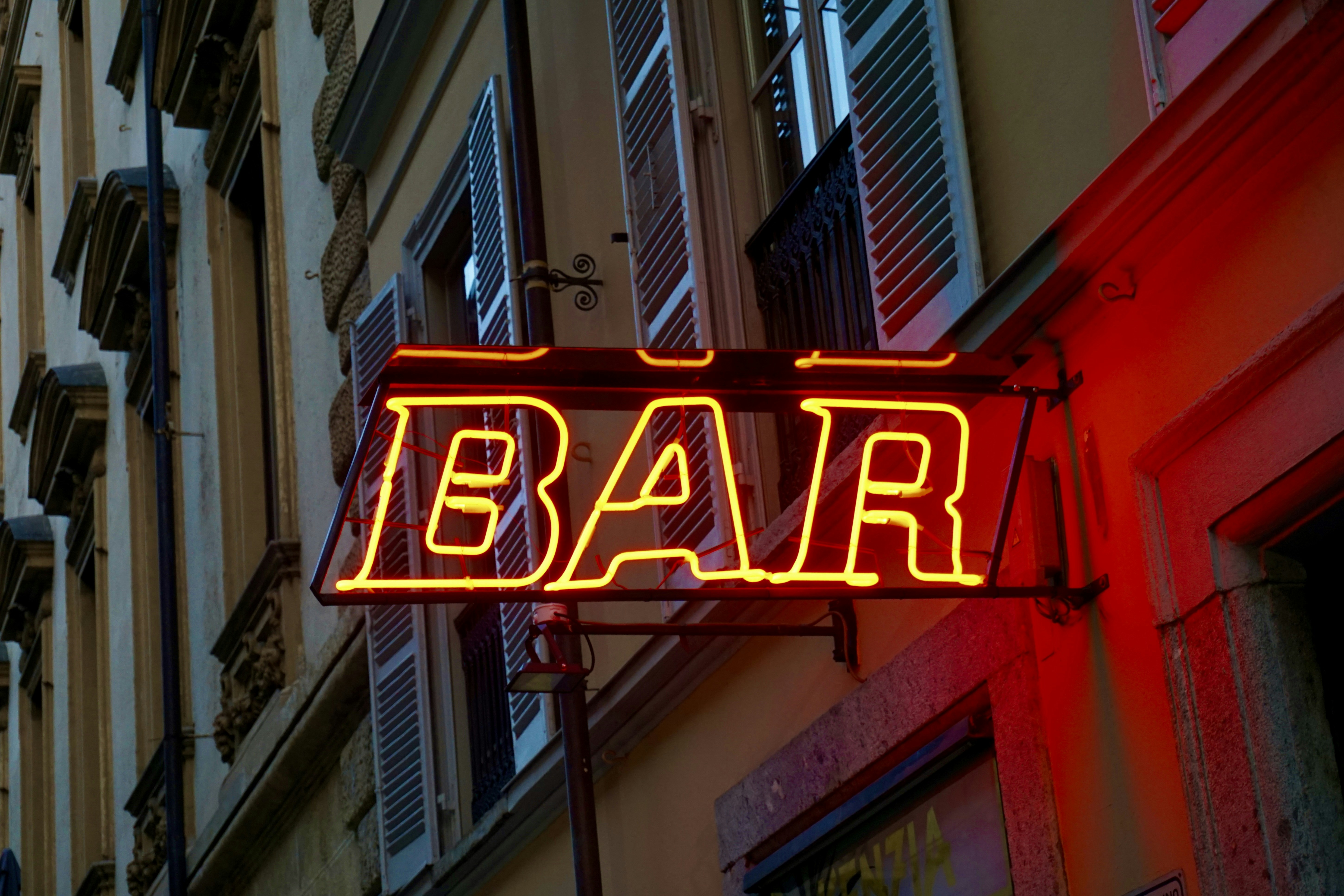 A neon bar sign glows at night