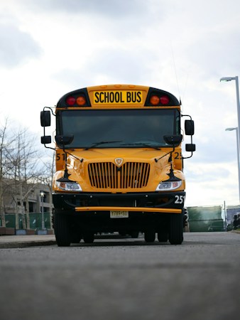 Front view of a yellow school bus on a city street, similar to the CCSD buses that carry students in Henderson