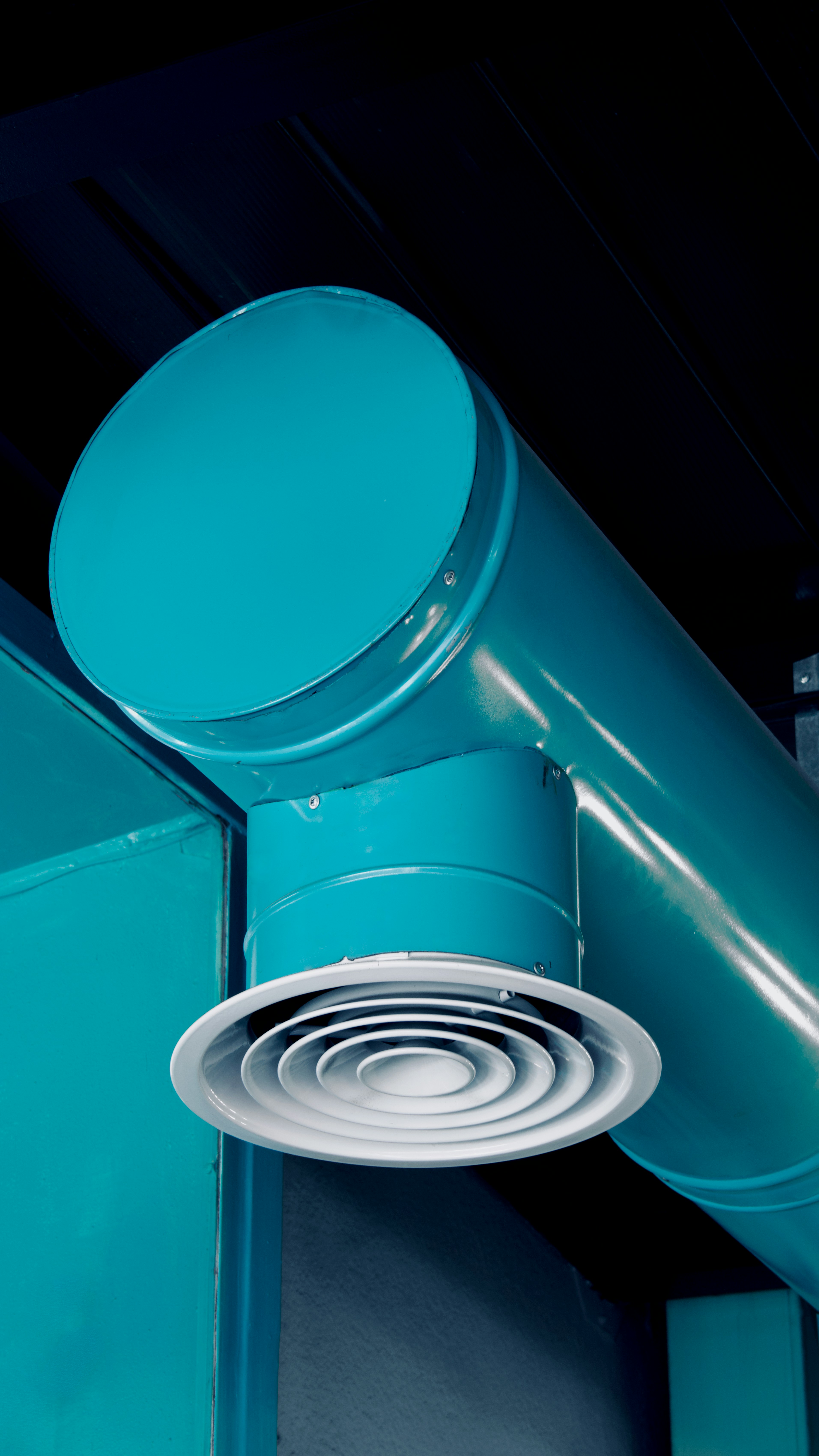 Turquoise industrial pipes and air vent
