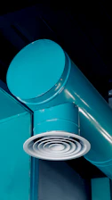 Turquoise industrial pipes and air vent