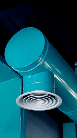 Turquoise industrial pipes and air vent