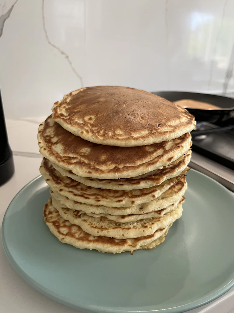 Tall stack of golden pancakes
