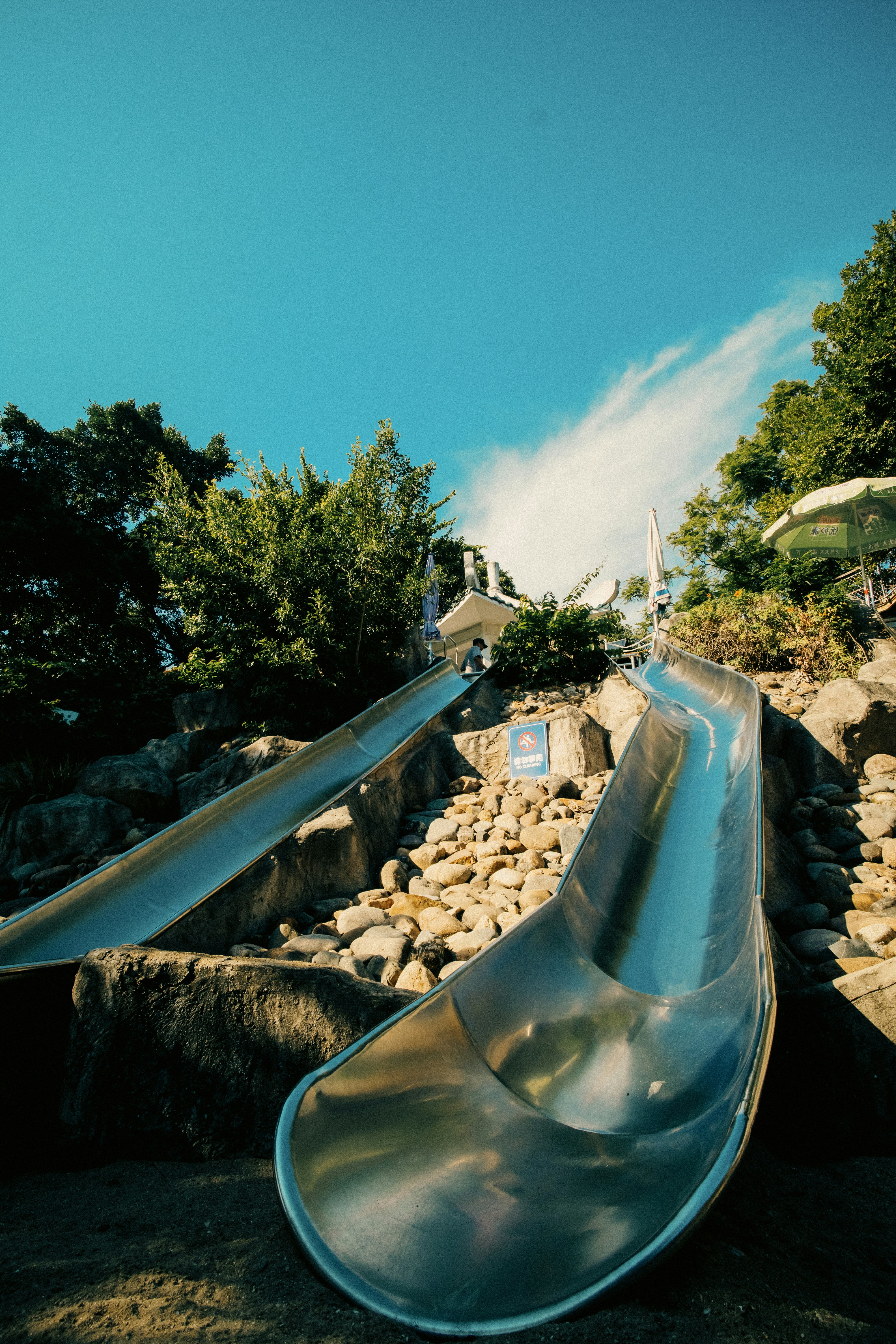 Two metal slides on a sunny day