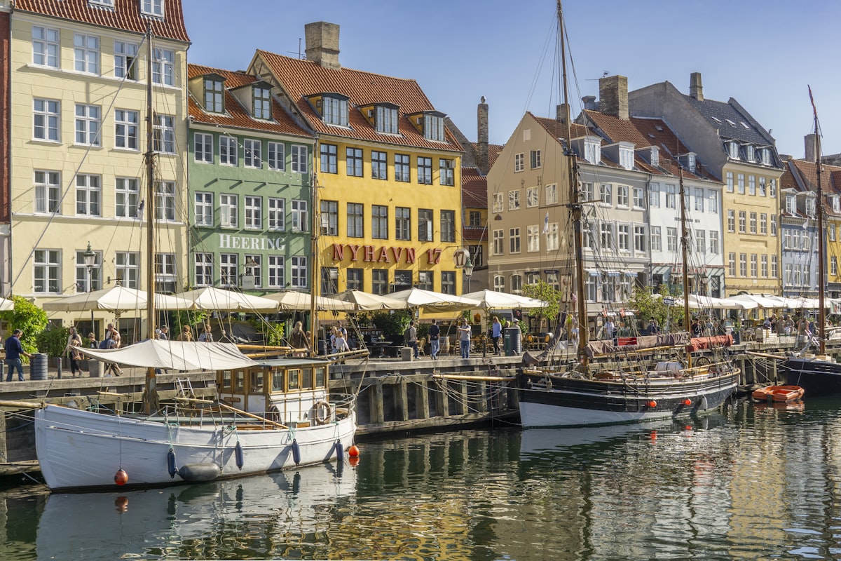 Copenhagen Christianshavn — colourful buildings lining a canal with boats and cafés in the waterfront neighbourhood