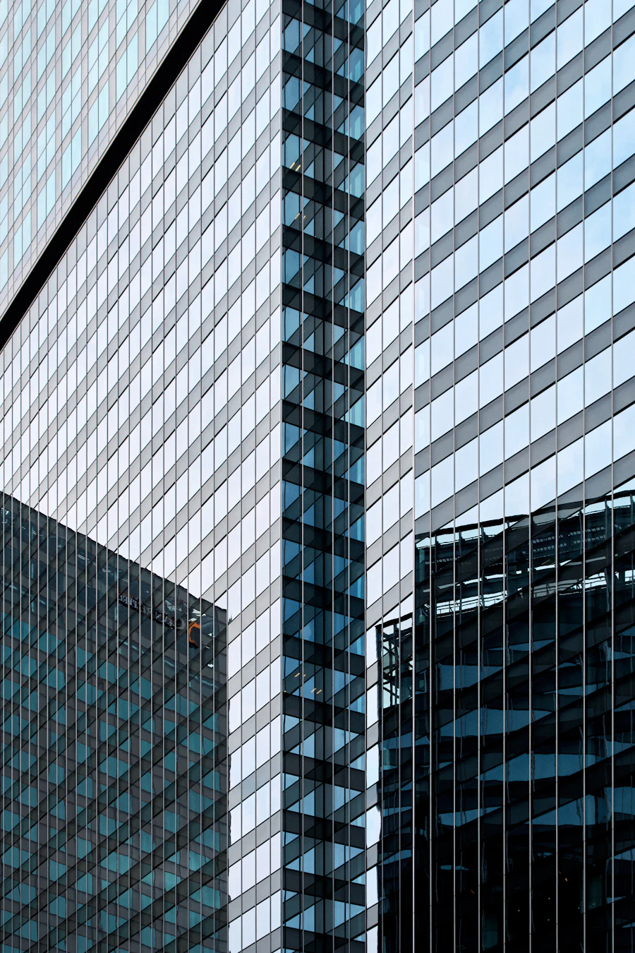Geometric glass facades reflecting blue sky
