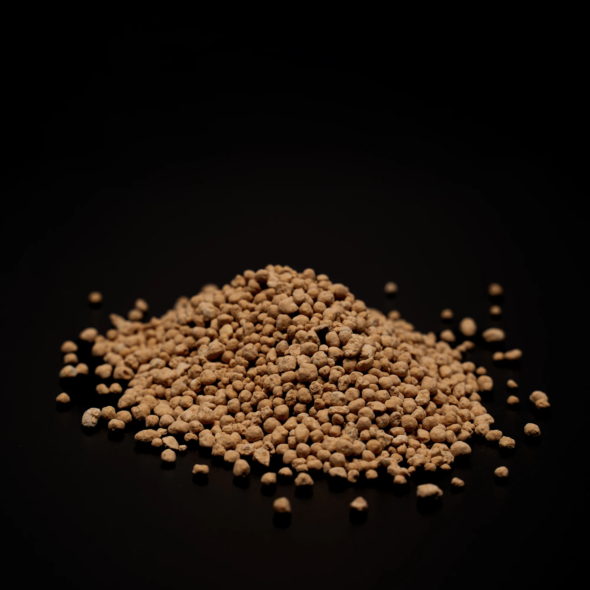 A pile of tan bio-organic fertilizer granules