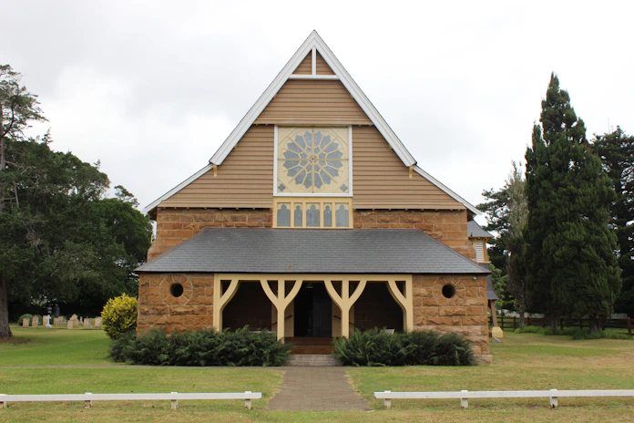 A stone church with a large rose window.