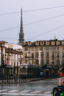 Tram on a rainy day with mole antonelliana in background
