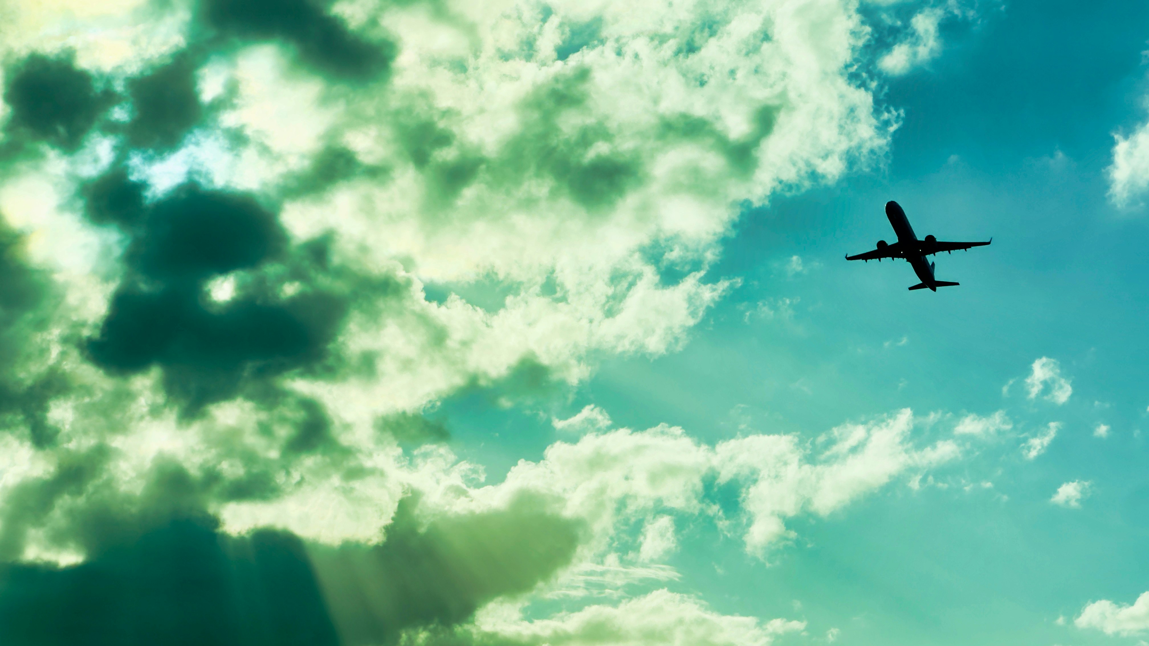 Airplane flying through a cloudy sky.