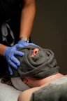Spa treatment with a towel covering the face.