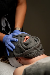 Spa treatment with a towel covering the face.
