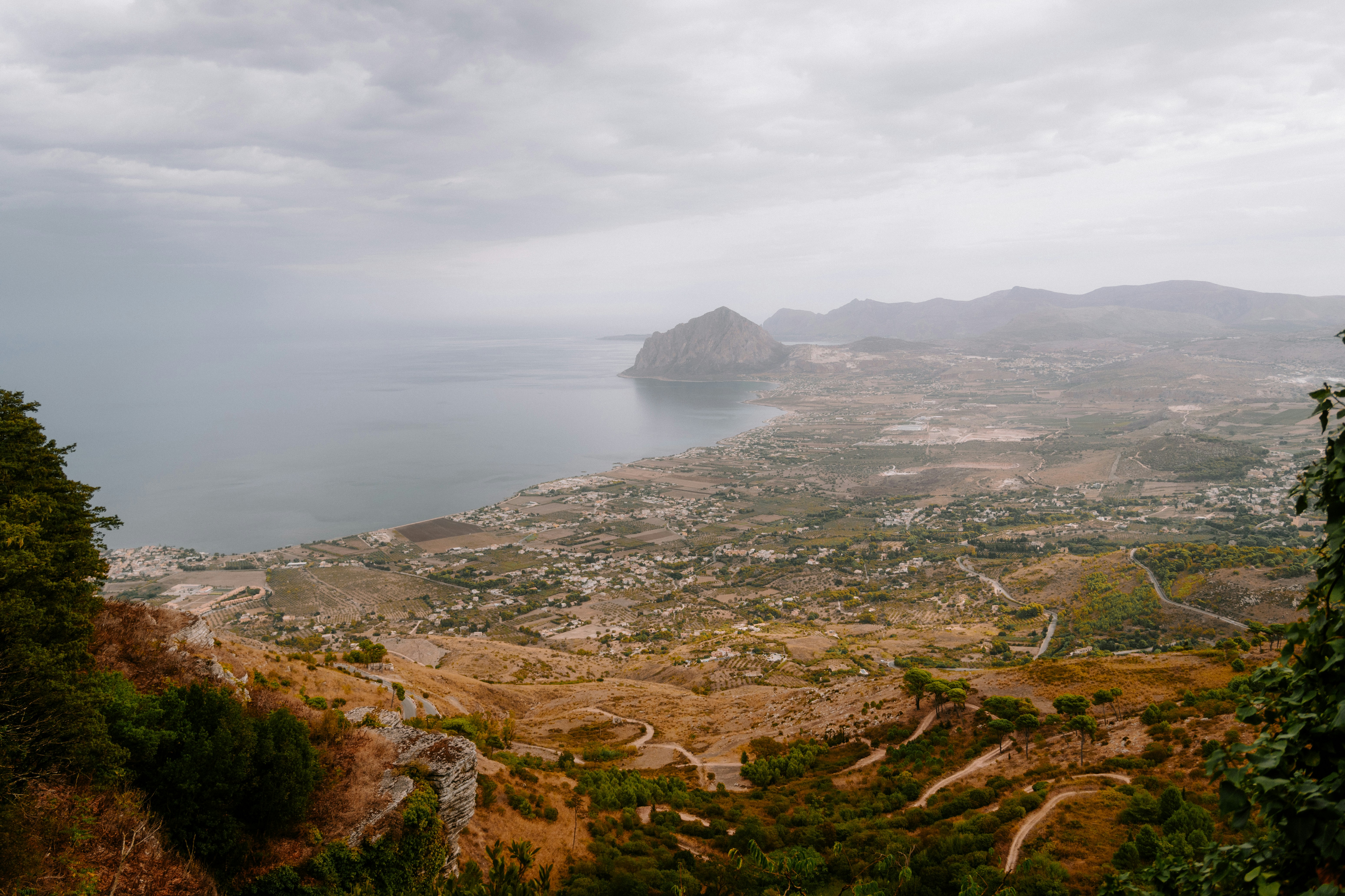 Coastal town nestled between mountains and sea.
