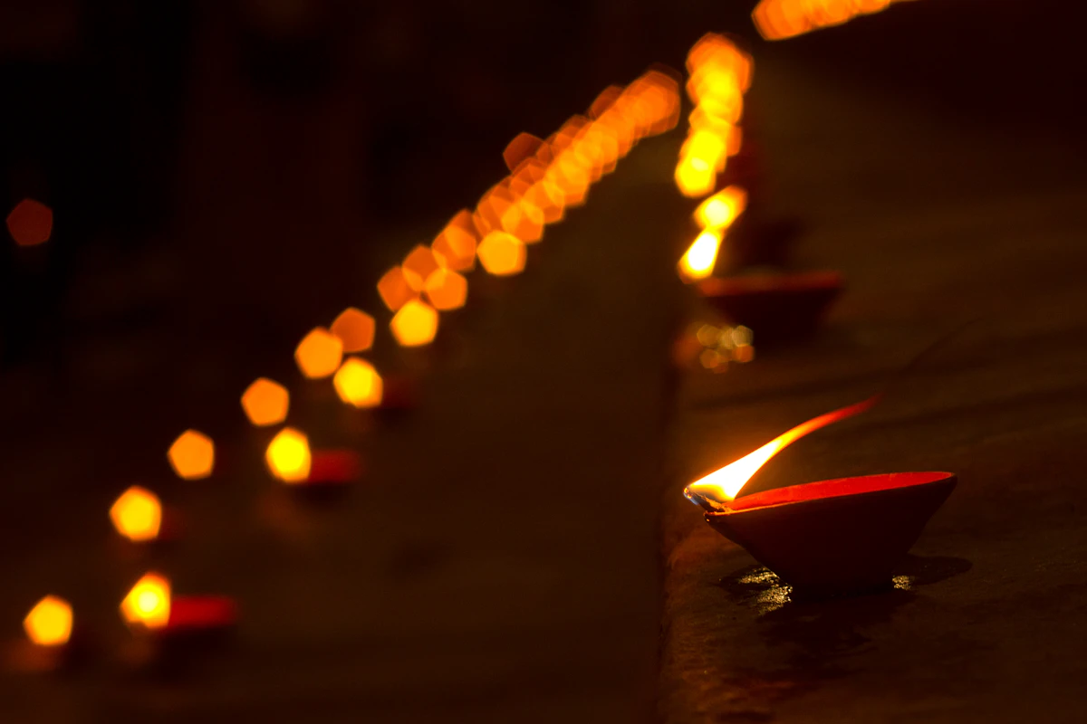 A row of oil lamps at night, closer to a vigil than to a gym session