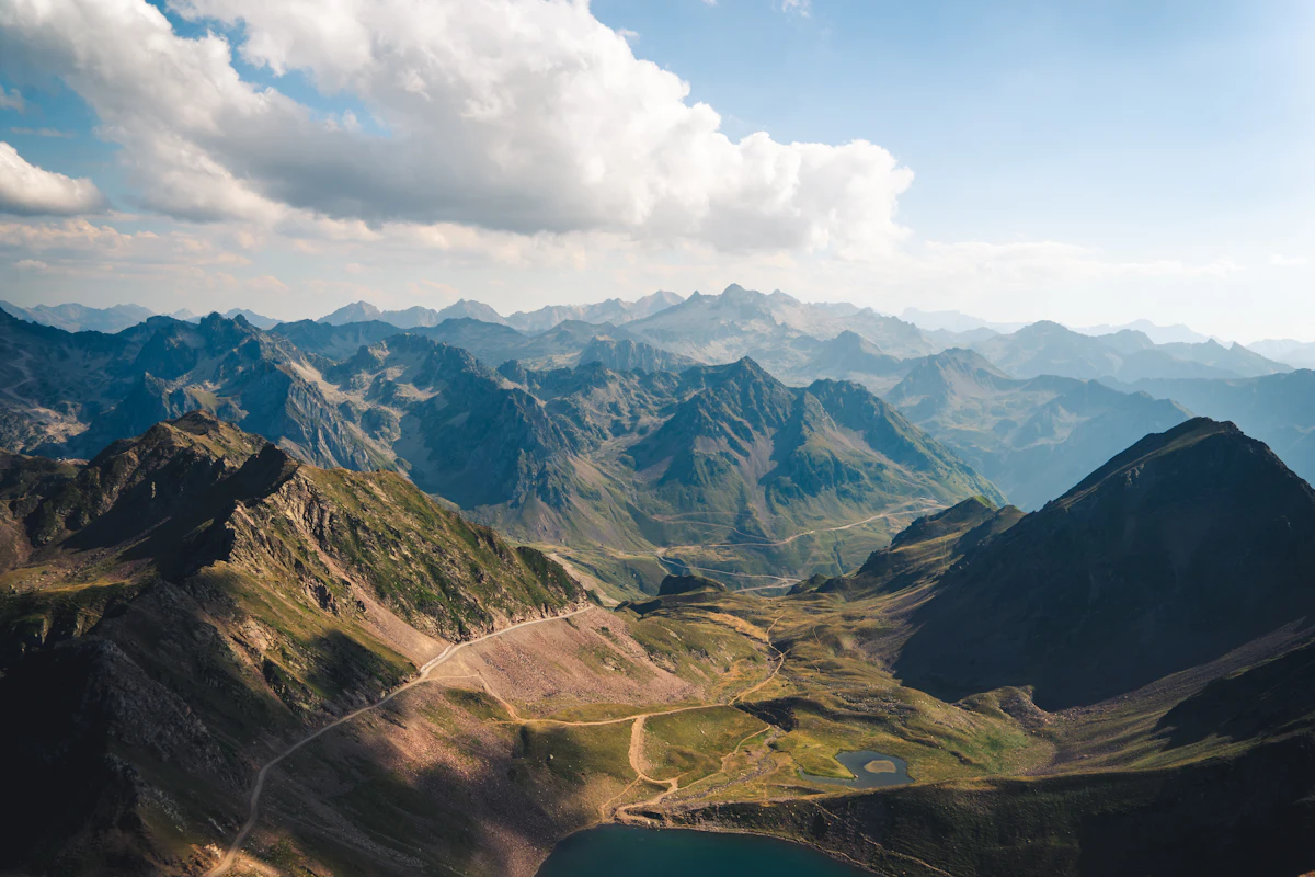 Ridge after ridge of the Pyrenees seen from the Pic du Midi de Bigorre, with a lake in the valley below