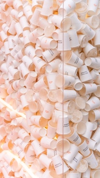 A large pile of white disposable coffee cups.