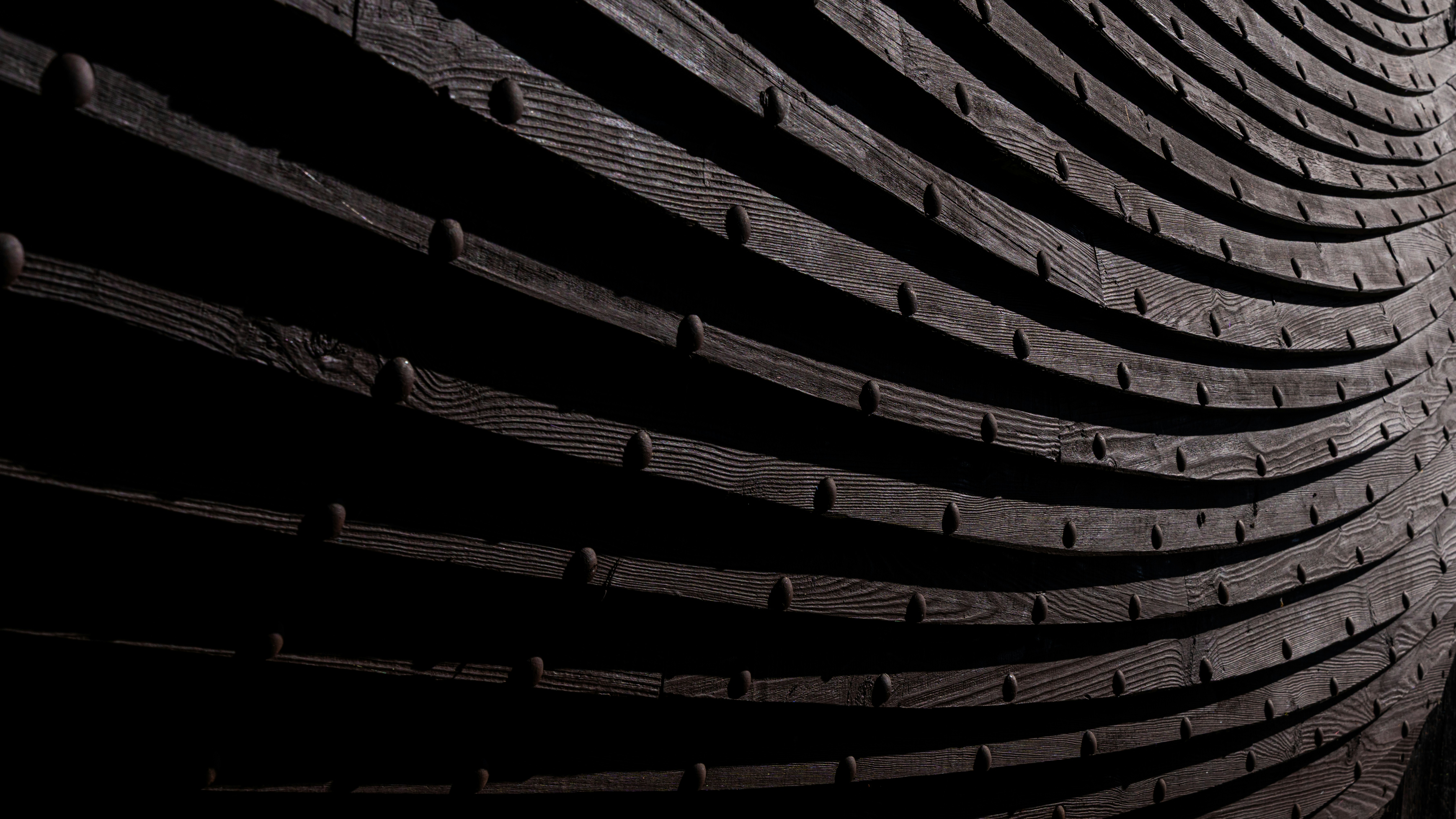 Dark wooden planks form a curved pattern