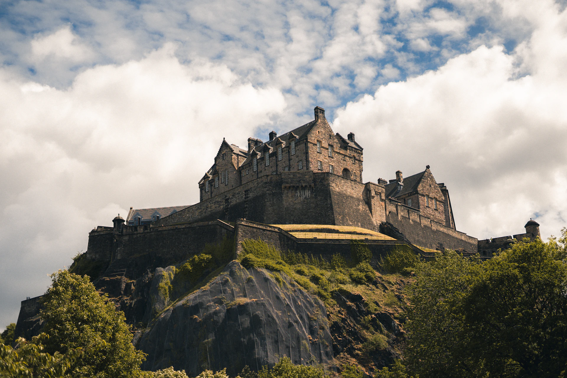 Historic castle perched on a rocky outcrop under clouds