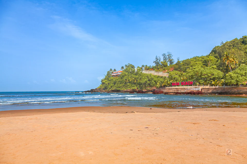 Vagator beach with the green headland of Chapora in the background