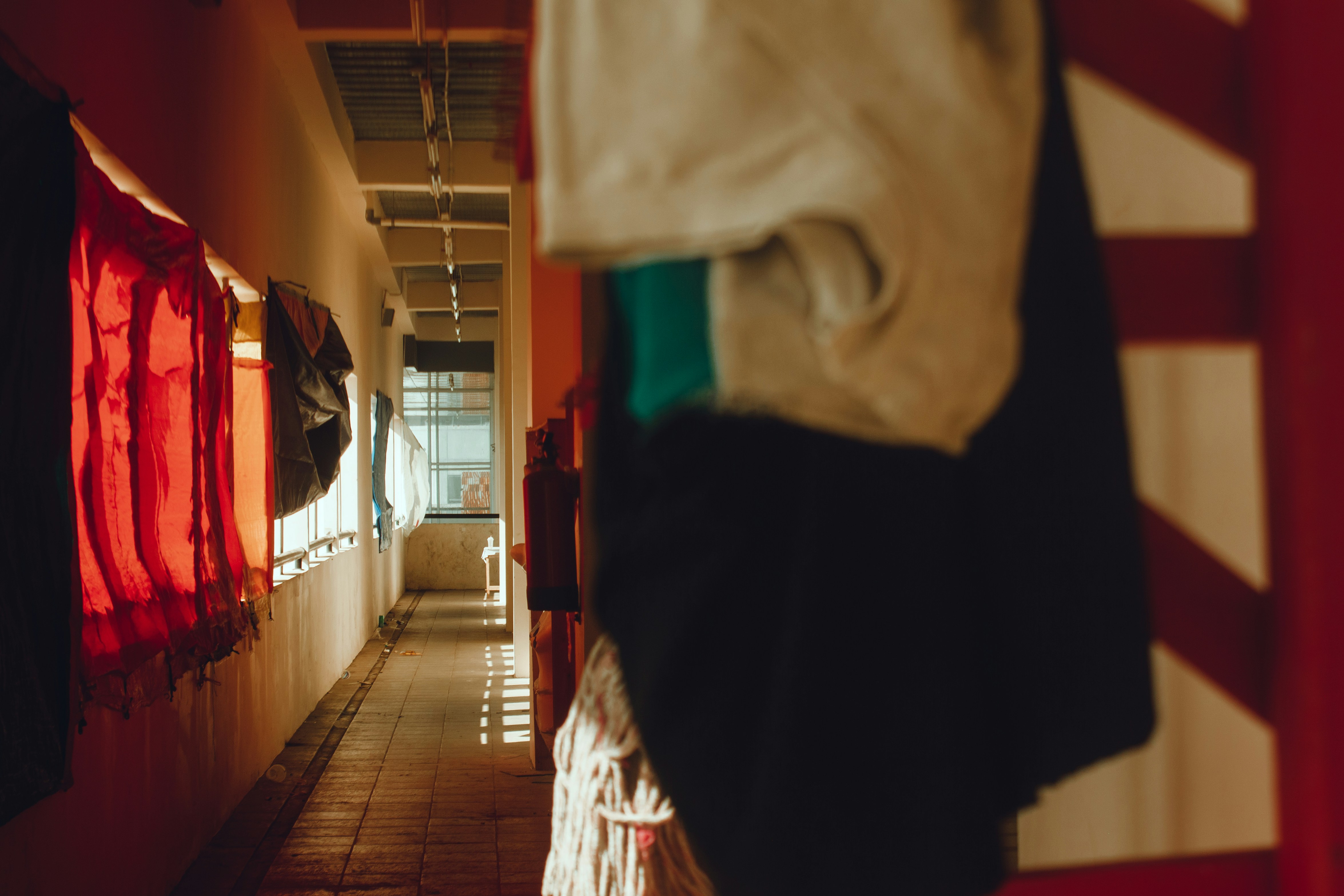 Hallway with clothes hanging on the wall