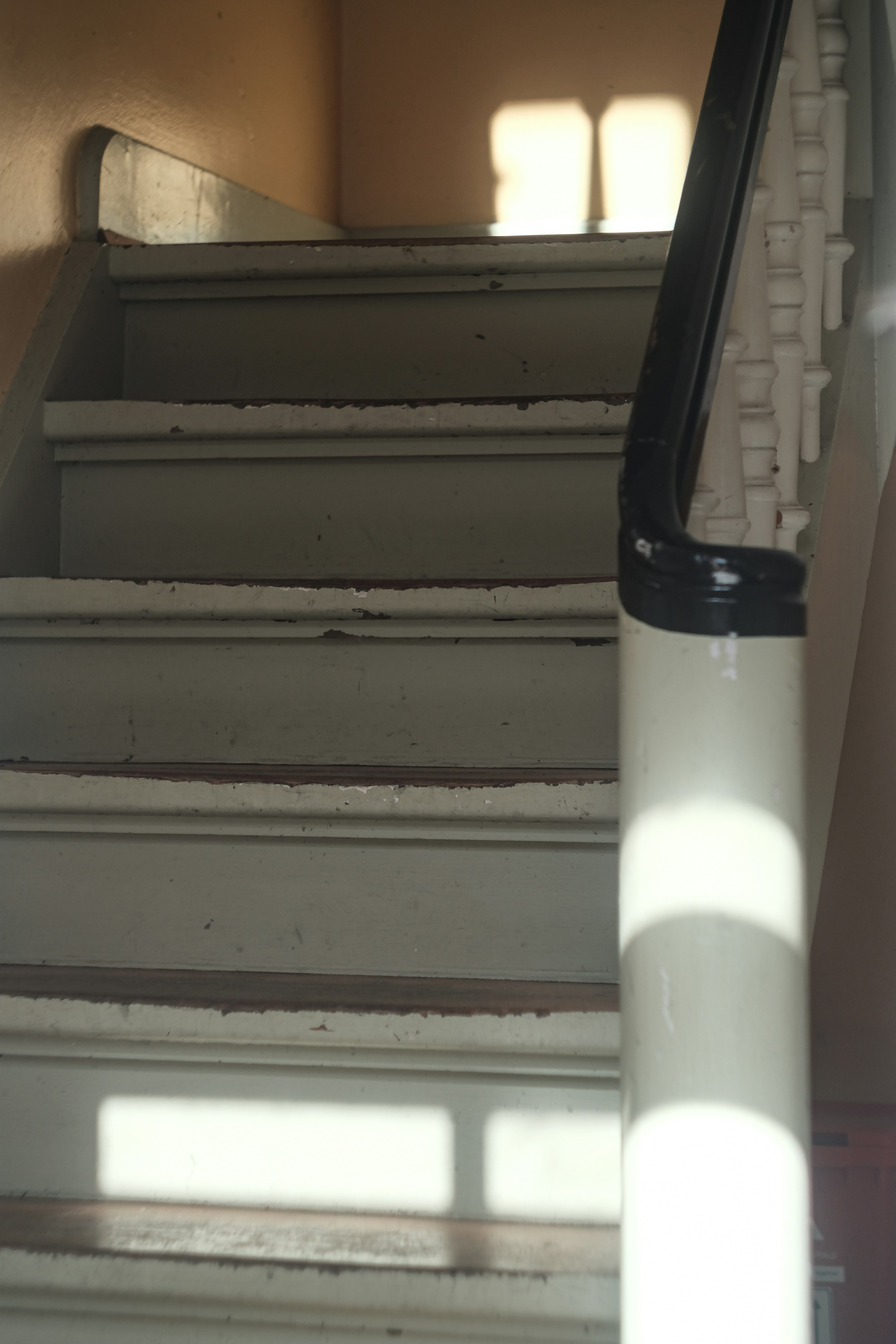 Sunlight streams onto a wooden staircase.