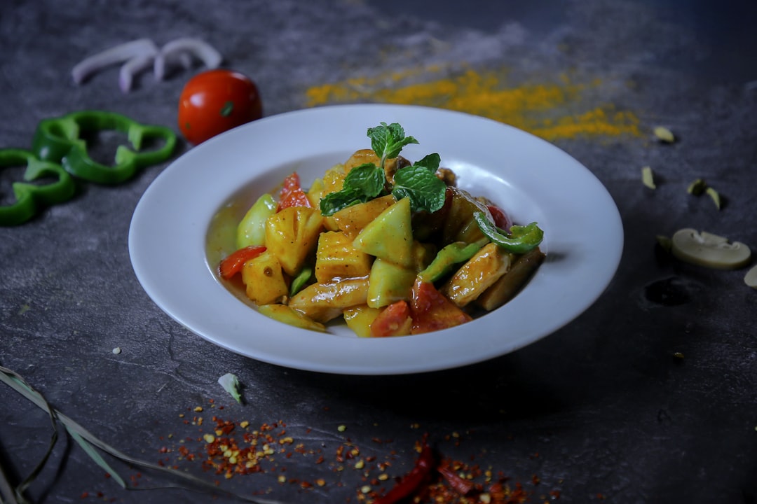 A colorful chicken stir-fry with various vegetables in a wok.