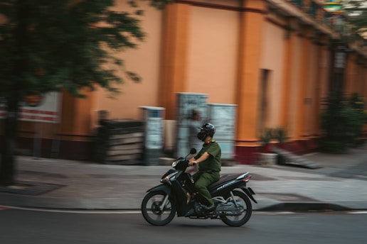Man in uniform rides a motorcycle on street