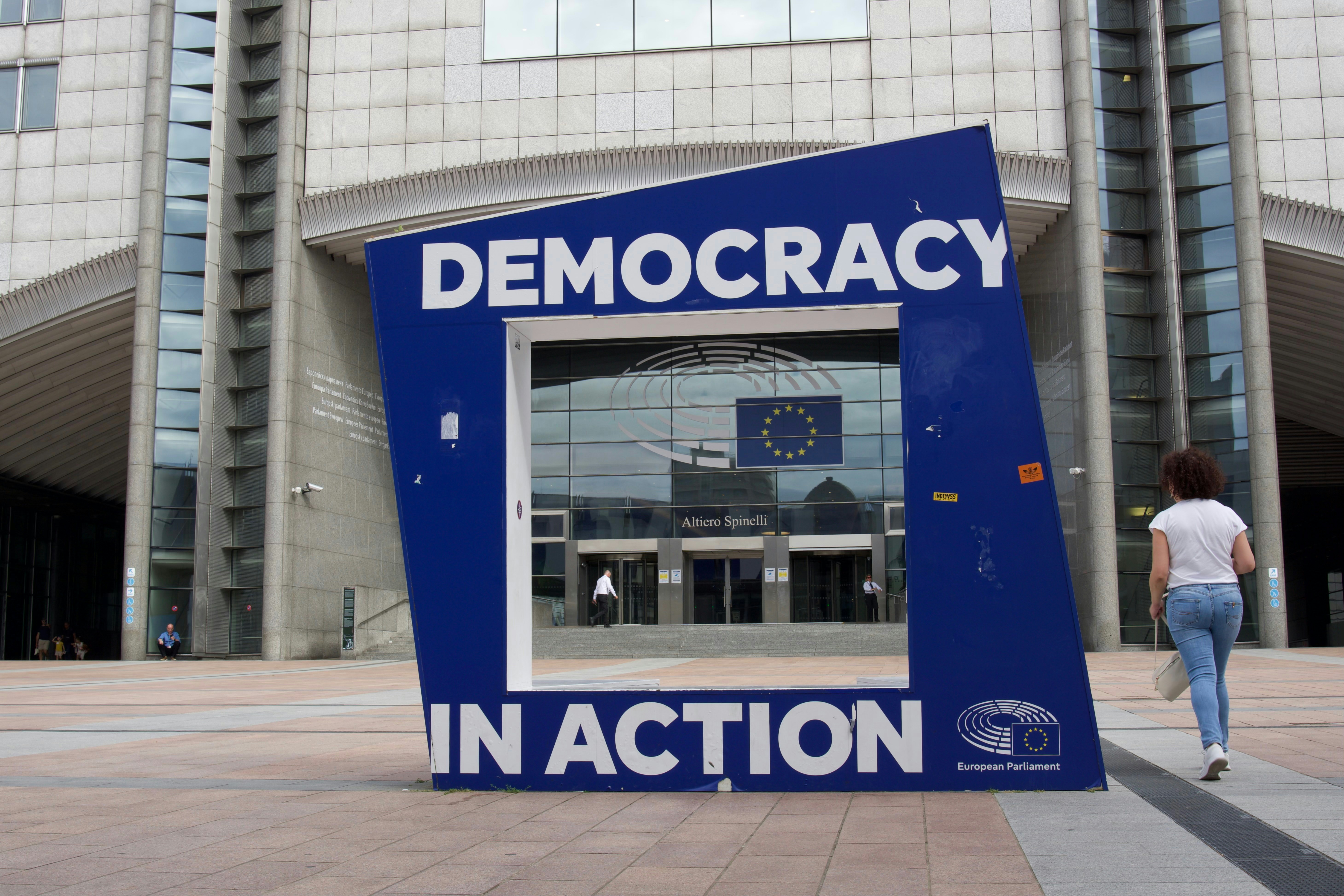 Large blue structure with "democracy in action" text.