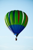 A colorful hot air balloon against a clear blue sky.