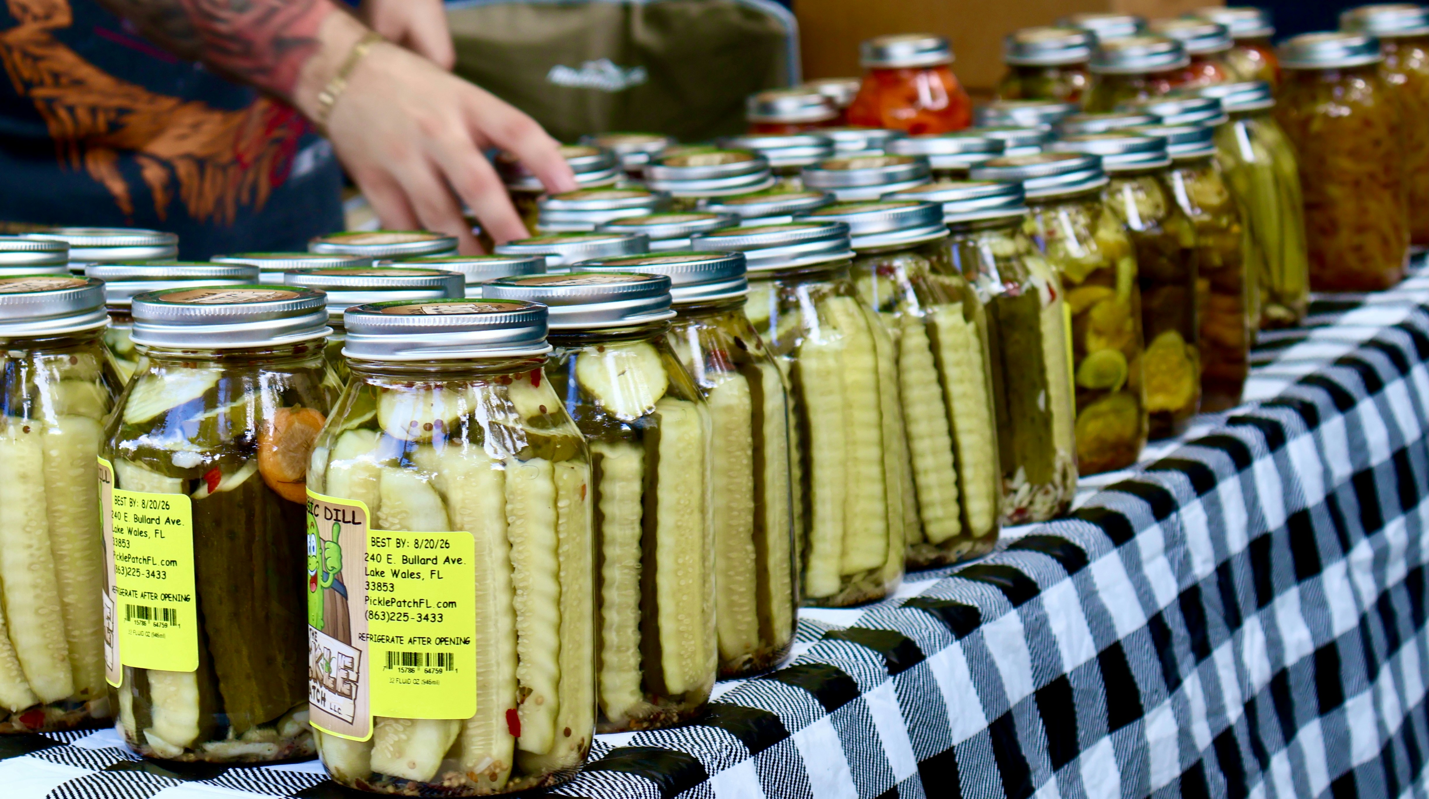 Jars of pickled vegetables lined up on a table.