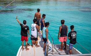 Group of men on a boat in clear blue water
