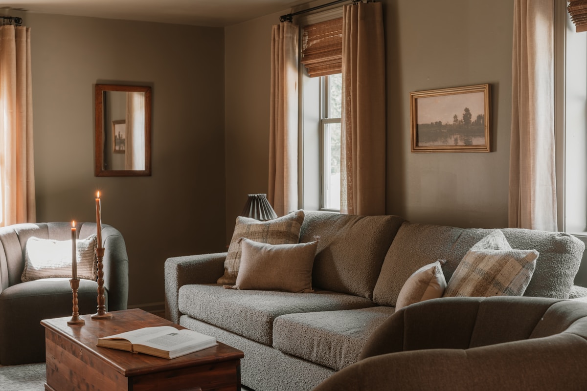 cozy apartment living room with earth tones candles and throw pillows