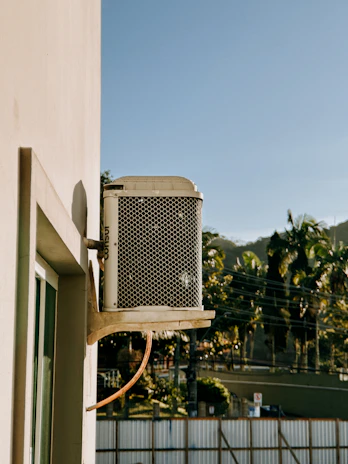 Outdoor air conditioning unit mounted on a wall.