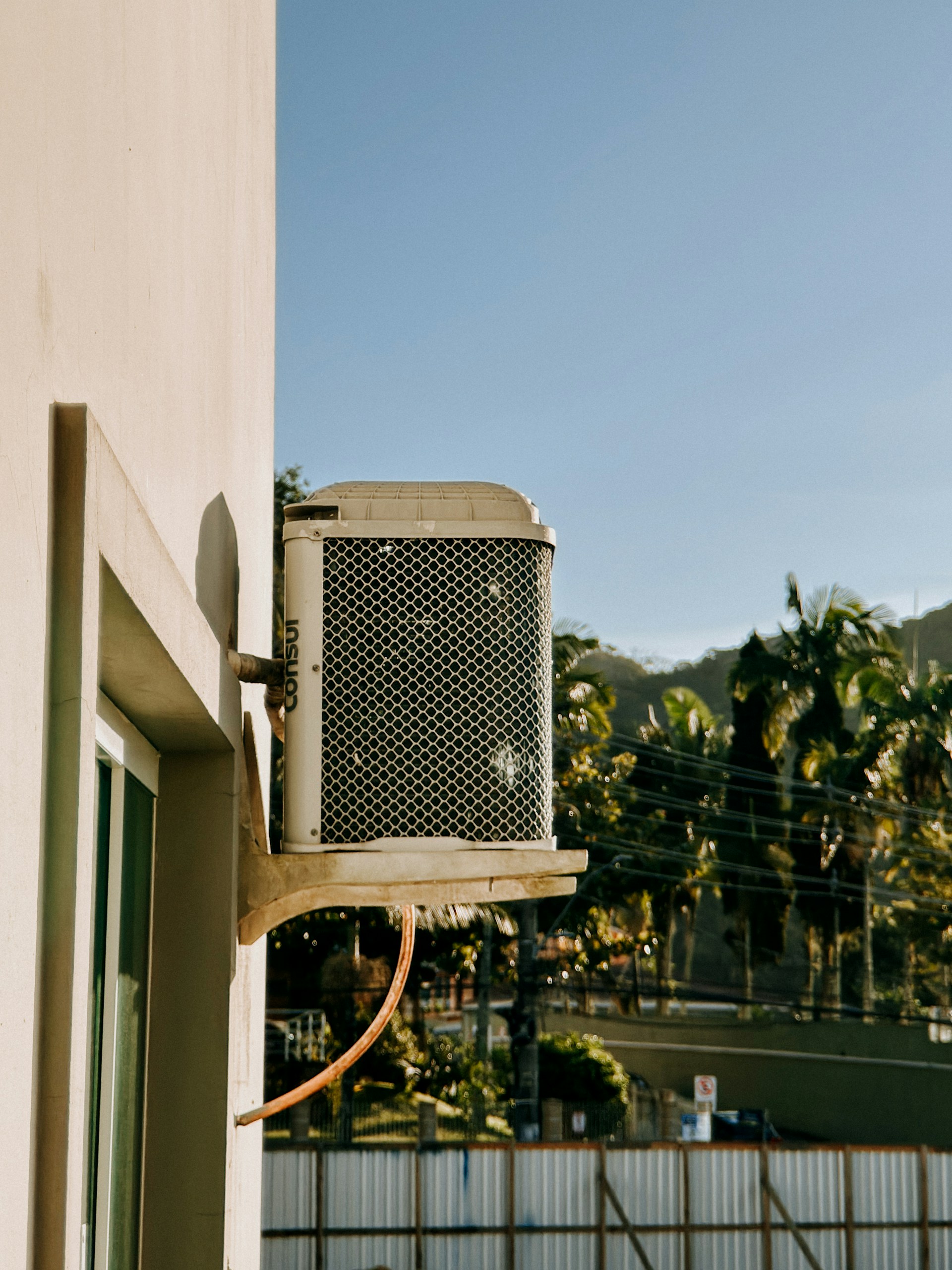 Outdoor air conditioning unit mounted on a wall.