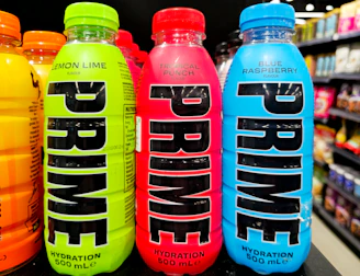 Three prime hydration drinks in neon colors