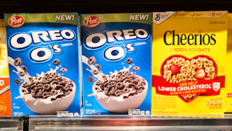 Boxes of oreo o's and cheerios cereal on shelf
