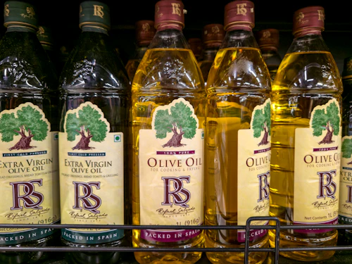 Bottles of oil arranged on a shelf