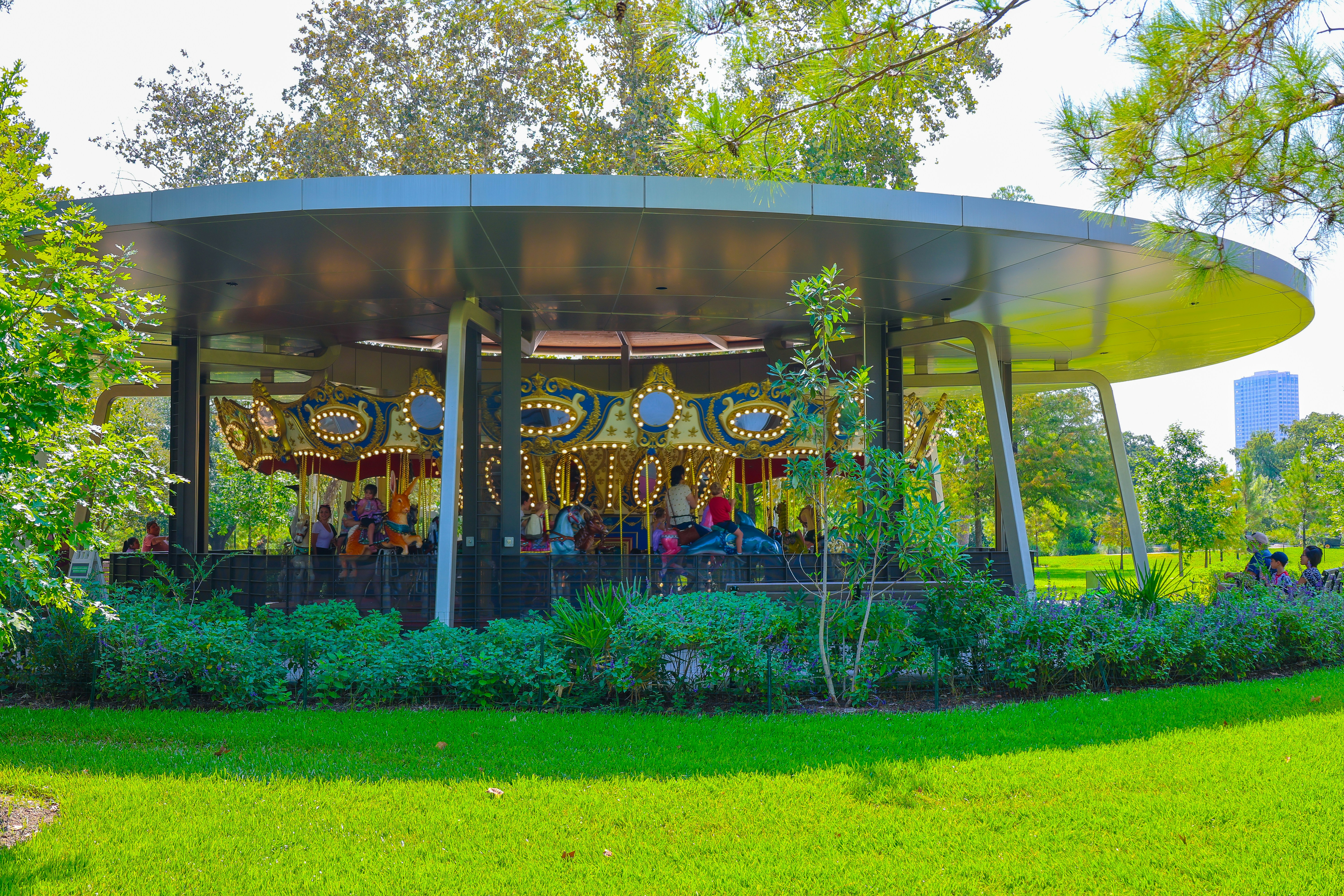 Carousel in a park surrounded by greenery