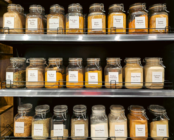 Jars of spices and seasonings neatly arranged on shelves.